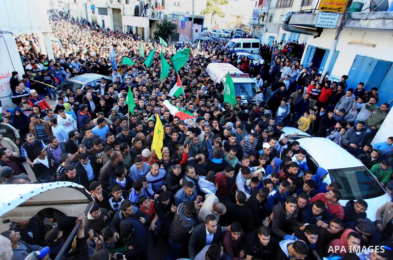Palestinians carry the body of Mohammad Mubarak, 18, during his funeral at the Jalazoun refugee camp near the West Bank city of Ramallah, Wednesday, Jan. 29, 2014. Israeli troops shot Mubarak to death on Wednesday in an...
