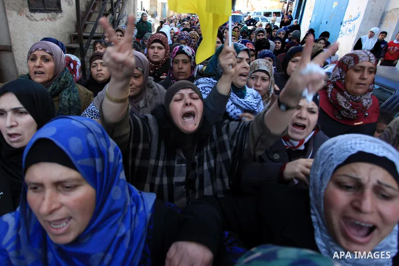 Palestinian women mourn during the funeral of Mohammad Mubarak, 18, at the Jalazoun refugee camp near the West Bank city of Ramallah, Wednesday, Jan. 29, 2014. Israeli troops shot Mubarak to death on Wednesday in an inci...