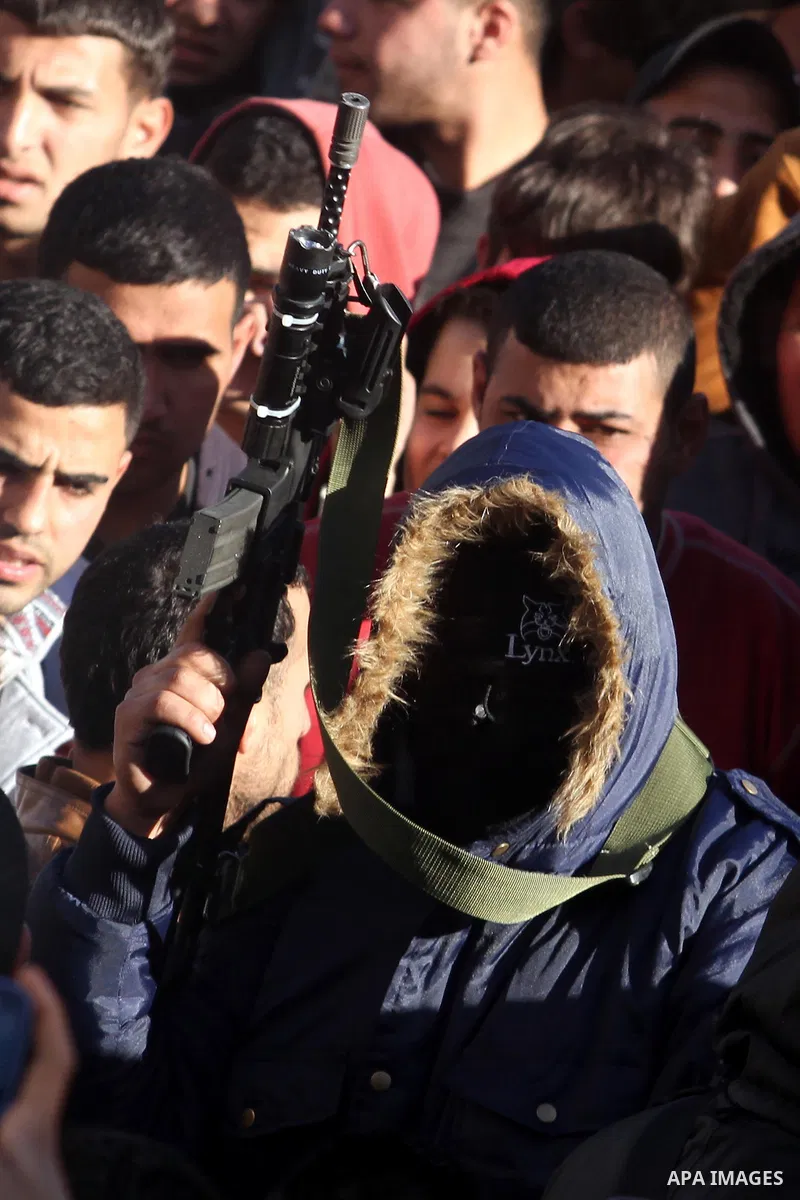 A Palestinian gunman holds his weapon during the funeral of Mohammad Mubarak, 18, in the Jalazoun refugee camp near the West Bank city of Ramallah, Wednesday, Jan. 29, 2014. Israeli troops shot Mubarak to death on Wednes...