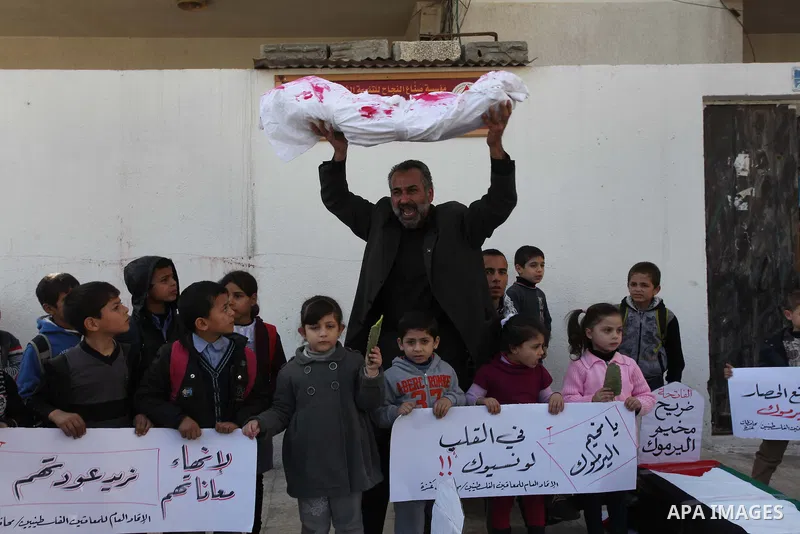 Palestinian children take part in a protest to show solidarity with Palestinian refugees Syria's main refugee camp Yarmouk, in Gaza City on January 30, 2014. Photo by Ashraf Amra