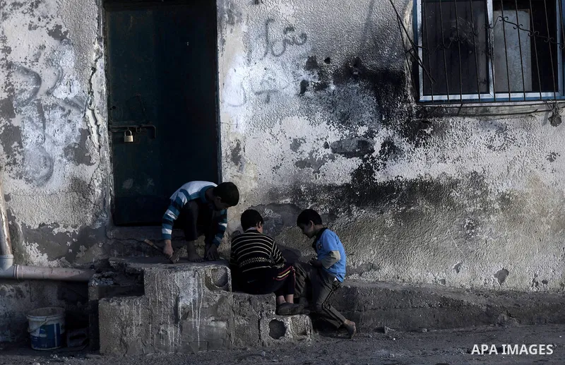Palestinian children play at the entrance of their family's house at al-Shati refugee camp in the west Gaza City on January 30, 2014. Photo by Abdullah Jadallah
