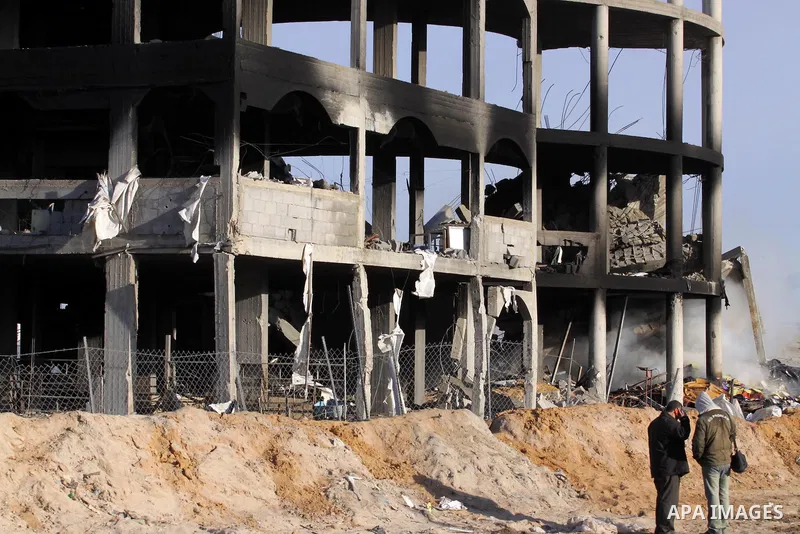 Palestinians inspect a building destroyed by an Israeli airstrike in Beit Lahia, northern Gaza Strip, on January 30, 2014. Israeli fighter jets attacked training sites of Ezzedine al-Qassam Brigades, Hamas's armed wing,...