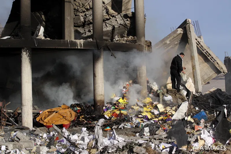 A Palestinian policeman inspects a building destroyed by an Israeli airstrike in Beit Lahia, northern Gaza Strip, on January 30, 2014. Israeli fighter jets attacked training sites of Ezzedine al-Qassam Brigades, Hamas's...