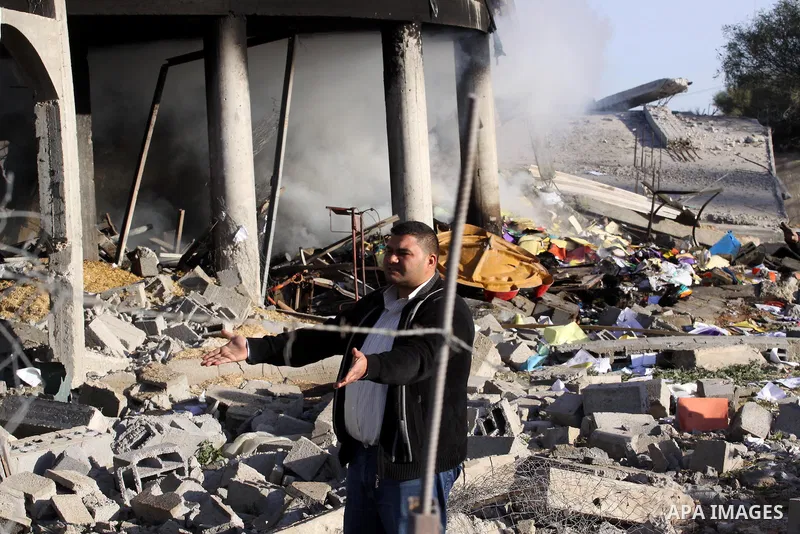 A Palestinian man inspects a building destroyed by an Israeli airstrike in Beit Lahia, northern Gaza Strip, on January 30, 2014. Israeli fighter jets attacked training sites of Ezzedine al-Qassam Brigades, Hamas's armed...