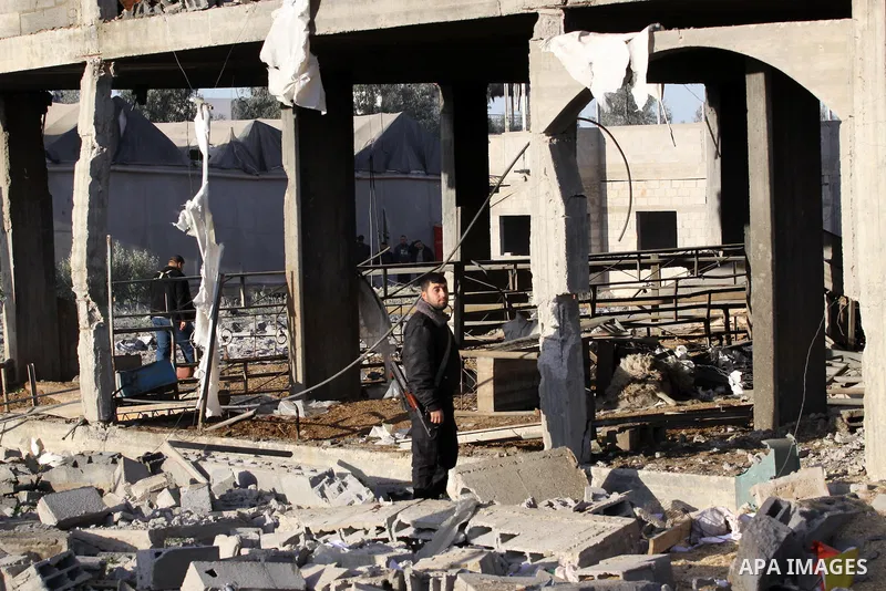 A Palestinian policeman inspects a building destroyed by an Israeli airstrike in Beit Lahia, northern Gaza Strip, on January 30, 2014. Israeli fighter jets attacked training sites of Ezzedine al-Qassam Brigades, Hamas's...