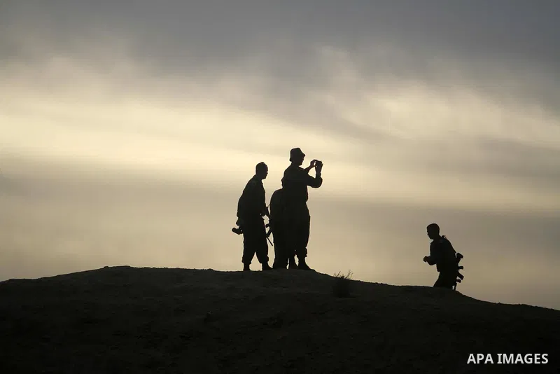 Israeli soldiers keep watching as Palestinian and foreign activists (not pictured) as they work at the site of the old village known as Ein Hijleh, in the Jordan valley near the West Bank City of Jericho, January 31, 201...