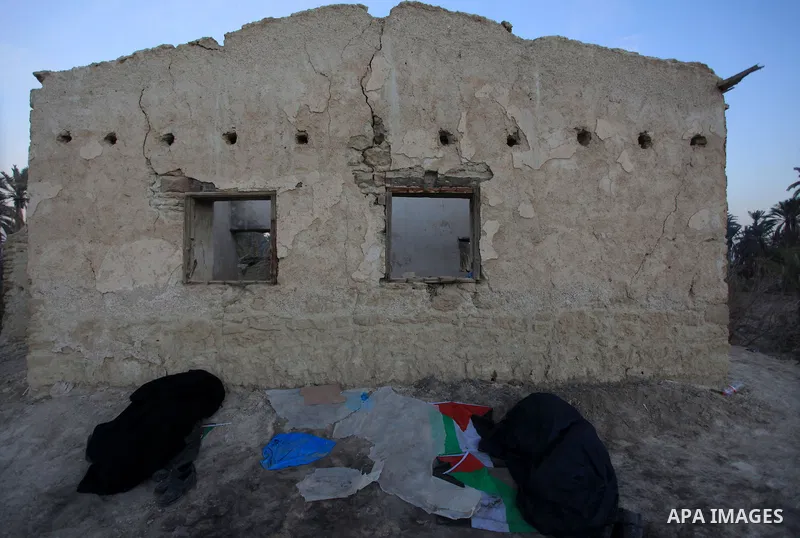 Palestinian and foreign activists sleep near an abandoned house in an old village known as Ein Hajla, in the Jordan Valley near the West Bank city of Jericho, Saturday, Feb. 1, 2014. Some 100 activists took part in a cam...