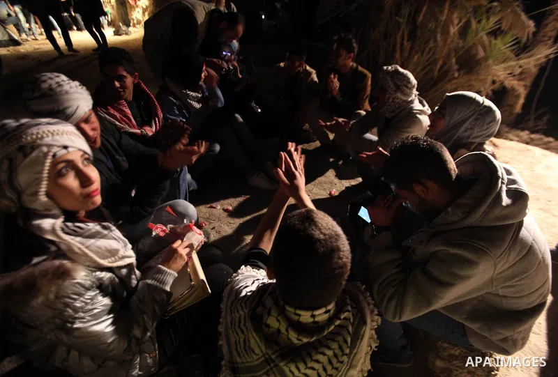 Palestinian and foreign activists sit at the site of the old village known as Ein Hijleh, in the Jordan valley near the West Bank City of Jericho Feb. 01, 2014. Hundreds of Palestinians announced today the launching of t...