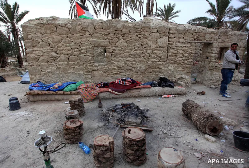 A Palestinian activist stands at the entrance of a structure at the site of the old village known as Ein Hijleh, in the Jordan valley near the West Bank City of Jericho Feb. 01, 2014. Hundreds of Palestinians announced t...