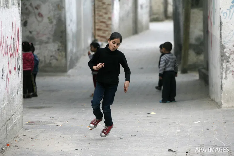 Palestinian children play at the street in Rafah refugee camp in the southern Gaza Strip, February 02, 2014. Photo by Eyad Al Baba