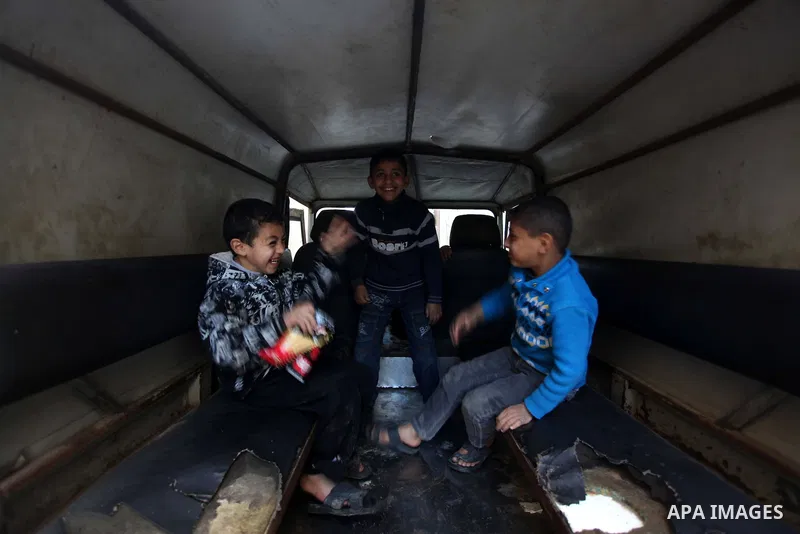 Palestinian children play in a car outside their family's houses at al-Shati refugee camp, in the west Gaza City on February 02, 2014. Photo by Ashraf Amra