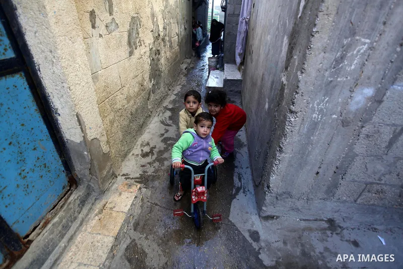 Palestinian children play outside their family's houses at al-Shati refugee camp, in the west Gaza City on February 02, 2014. Photo by Ashraf Amra
