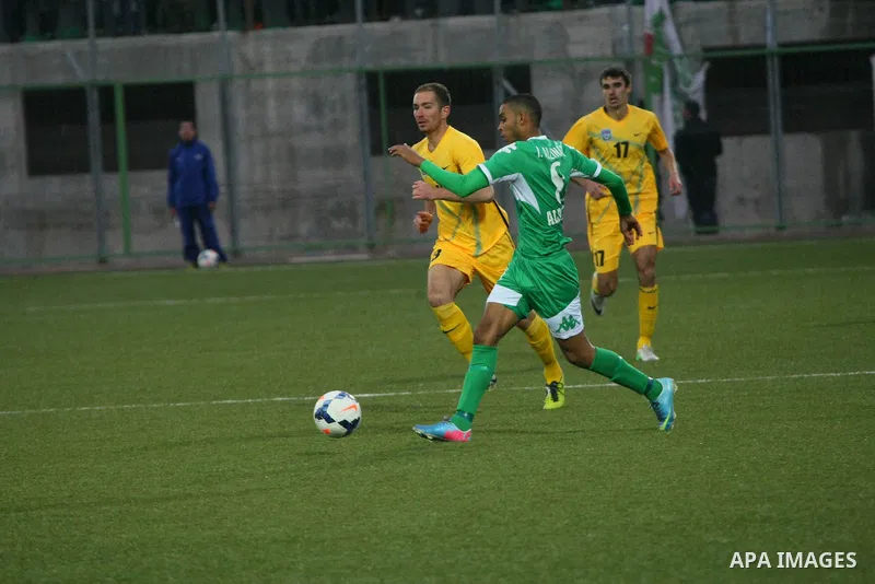 Palestinian players of al-Dahriya Youth Club (green) compete against Kyrgyz team Olay Osh (yellow) during the preliminary round of Asian Football Confederation (AFC) Cup, in the West Bank City of Hebron, February 02, 201...