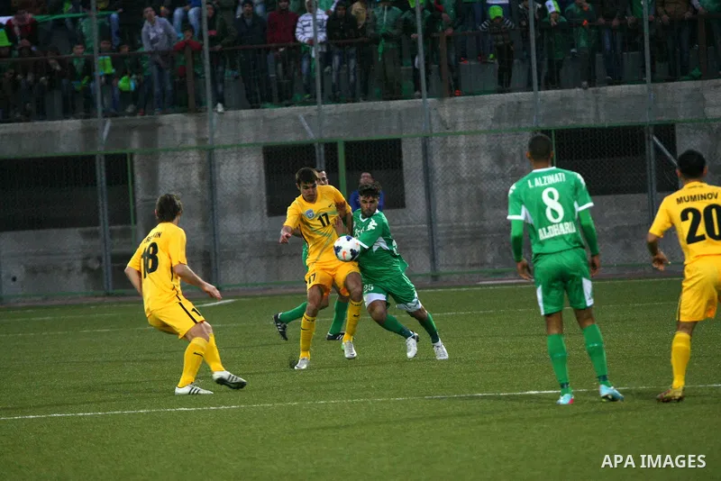 Palestinian players of al-Dahriya Youth Club (green) compete against Kyrgyz team Olay Osh (yellow) during the preliminary round of Asian Football Confederation (AFC) Cup, in the West Bank City of Hebron, February 02, 201...