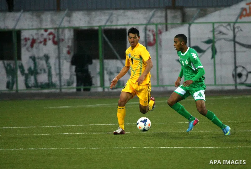 Palestinian players of al-Dahriya Youth Club (green) compete against Kyrgyz team Olay Osh (yellow) during the preliminary round of Asian Football Confederation (AFC) Cup, in the West Bank City of Hebron, February 02, 201...