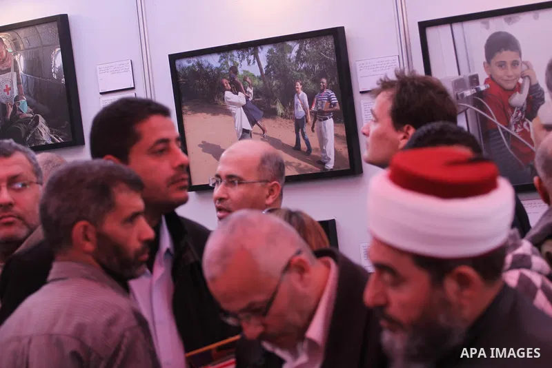 Palestinians attend the photo gallery organized by the International Committee of the Red Cross to mark the 150-year anniversary of its founding in Gaza City on Feb. 03, 2014. Photo by Mohammed Asad