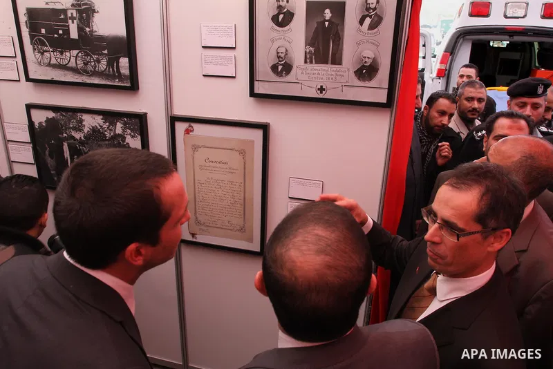 Palestinians attend the photo gallery organized by the International Committee of the Red Cross to mark the 150-year anniversary of its founding in Gaza City on Feb. 03, 2014. Photo by Mohammed Asad