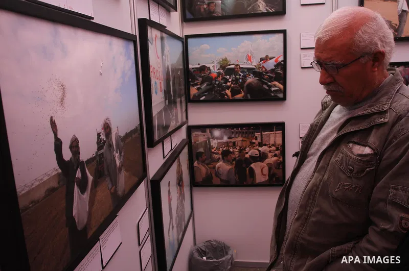 Palestinians attend the photo gallery organized by the International Committee of the Red Cross to mark the 150-year anniversary of its founding in Gaza City on Feb. 03, 2014. Photo by Mohammed Asad