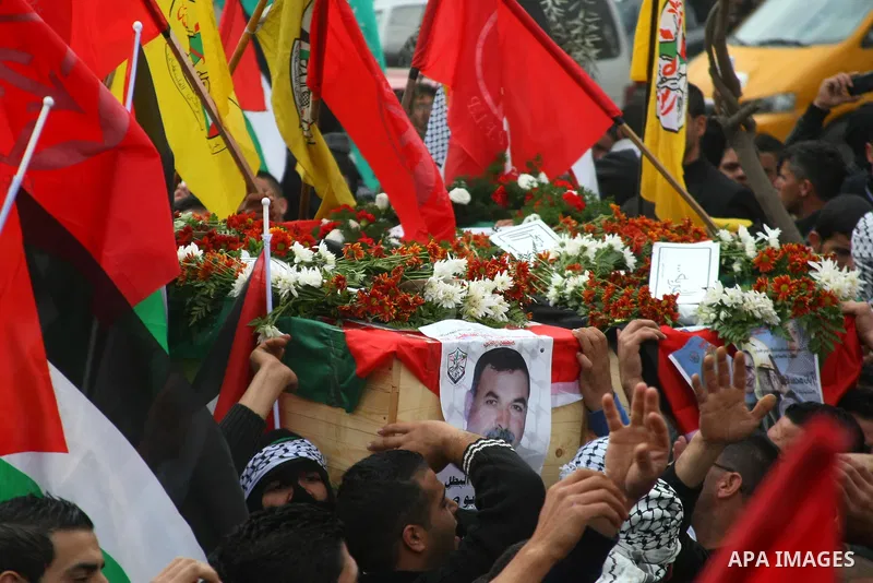 Palestinians carry coffins containing the remains of Ayat al-Akhras and Daoud Abu Swai during their funeral in Deheishe refugee camp in the West Bank town of Bethlehem February 3, 2014. Last month, Israel began to exhume...