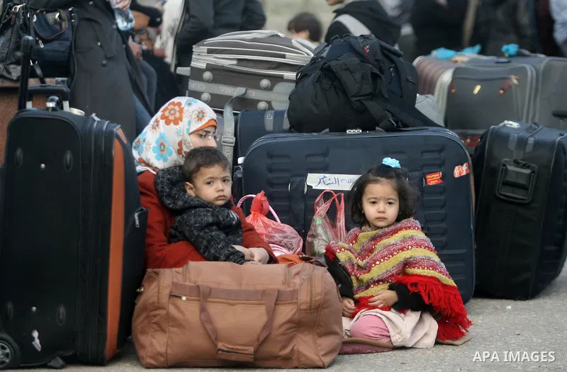 Palestinians, hoping to cross into Egypt, wait at the Rafah crossing between Egypt and the southern Gaza Strip on Feb. 04, 2014. Egyptian authorities partially opened the Rafah crossing, Gaza's main window to the world,...