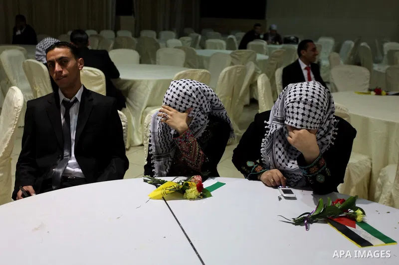 Palestinian couples take part in a mass wedding ceremony in Gaza City on February 04, 2014. Nearly 50 Palestinians were married in the Gaza Strip in a mass wedding funded by the office of Palestinian President Mahmoud Ab...