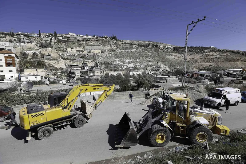 Israeli municipality workers use mechanical diggers to demolish a house belonging to a Palestinian family that the authorities believe without municipal permission in Jabal al-Mukabbir neighborhood south Jerusalem, on Fe...