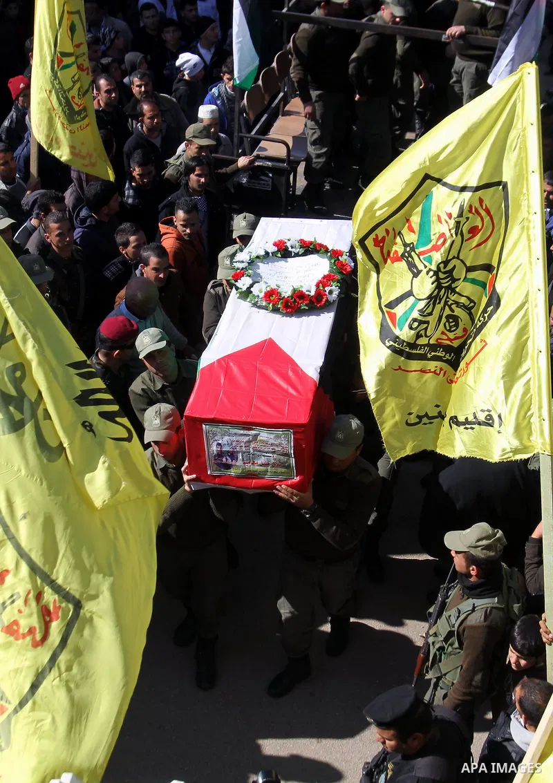 Palestinian security forces carry a coffin containing the remains of Jalal Mahameed, during a funeral in the West Bank City of Jenin, Feb. 05 , 2014. Israeli authorities handed over the remains of Jalal Mahameed, from th...