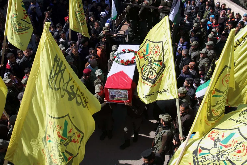 Palestinian security forces carry a coffin containing the remains of Jalal Mahameed, during a funeral in the West Bank City of Jenin, Feb. 05 , 2014. Israeli authorities handed over the remains of Jalal Mahameed, from th...