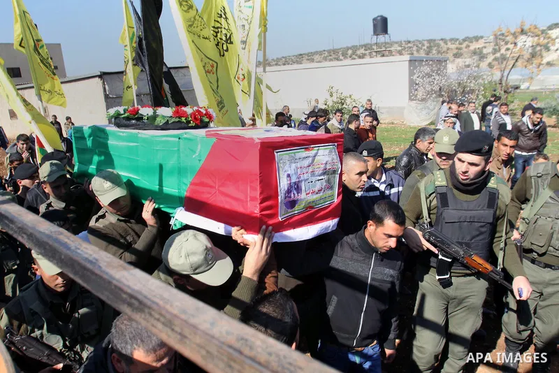 Palestinian security forces carry a coffin containing the remains of Jalal Mahameed, during a funeral in the West Bank City of Jenin, Feb. 05 , 2014. Israeli authorities handed over the remains of Jalal Mahameed, from th...