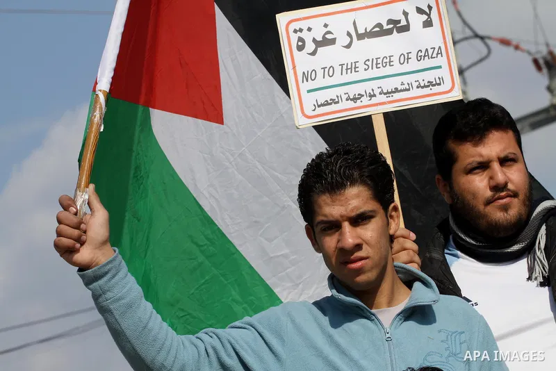 Palestinians take part in a protest against the Israeli blockade on Gaza, at Erez crossing between Israel and Gaza Strip Feb. 06, 2014. Israel imposed a blockade on Gaza in 2007 after Islamist group Hamas seized control...