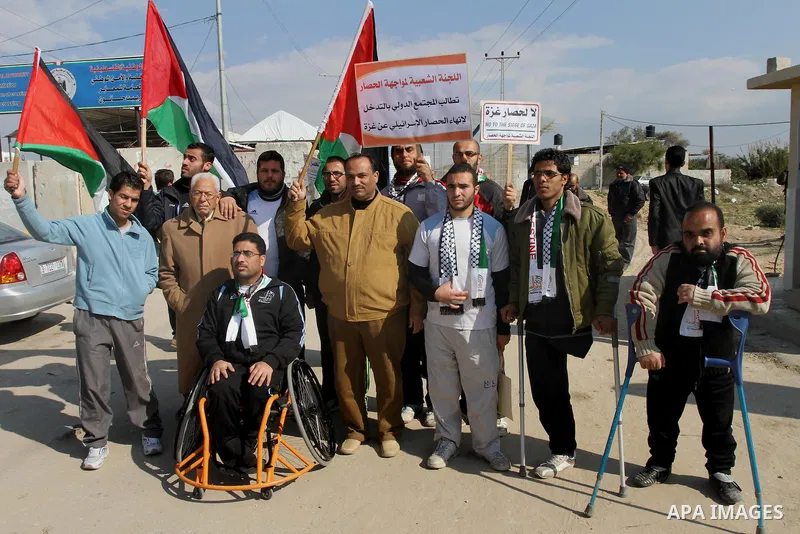 Palestinians take part in a protest against the Israeli blockade on Gaza, at Erez crossing between Israel and Gaza Strip Feb. 06, 2014. Israel imposed a blockade on Gaza in 2007 after Islamist group Hamas seized control...