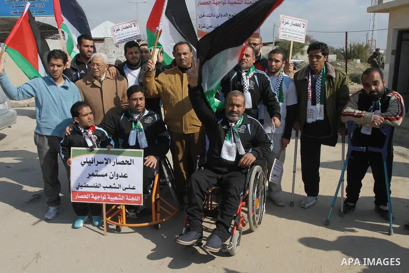 Palestinians take part in a protest against the Israeli blockade on Gaza, at Erez crossing between Israel and Gaza Strip Feb. 06, 2014. Israel imposed a blockade on Gaza in 2007 after Islamist group Hamas seized control...