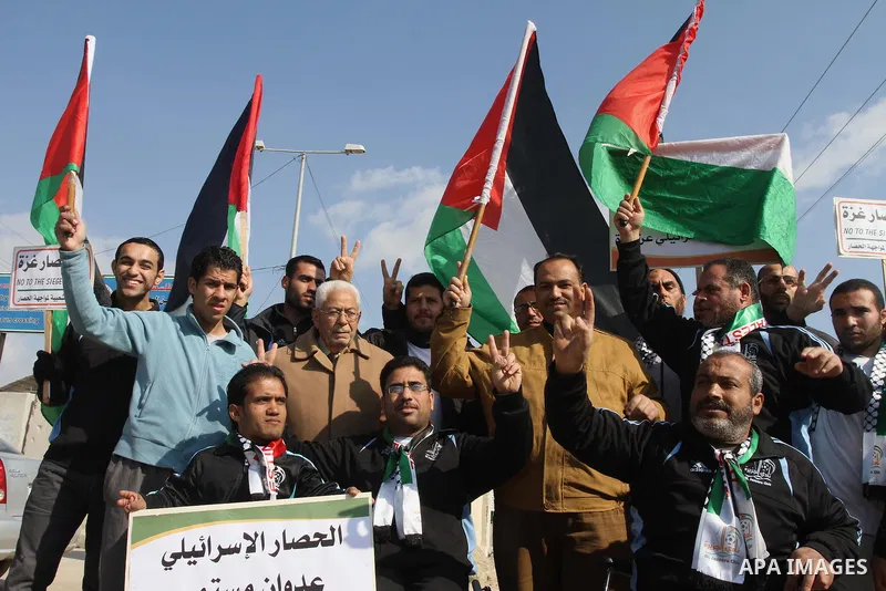 Palestinians take part in a protest against the Israeli blockade on Gaza, at Erez crossing between Israel and Gaza Strip Feb. 06, 2014. Israel imposed a blockade on Gaza in 2007 after Islamist group Hamas seized control...