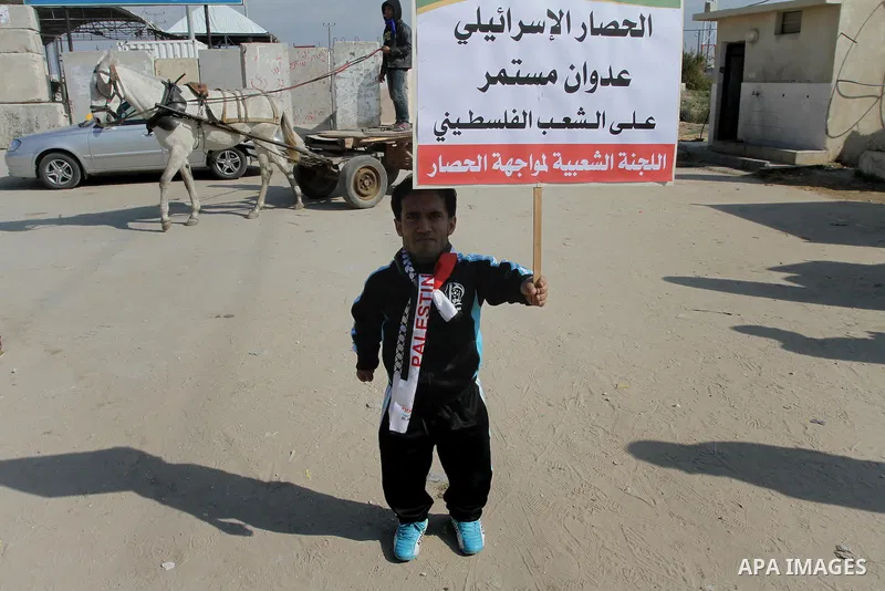 A-Palestinian disabled takes part in a protest against the Israeli blockade on Gaza, at Erez crossing between Israel and Gaza Strip Feb. 06, 2014. Israel imposed a blockade on Gaza in after Islamist group Hamas seized co...