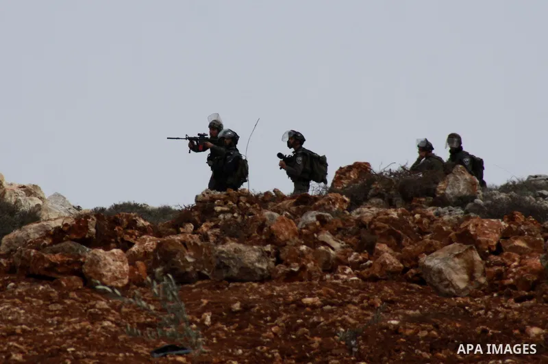 Israeli security forces fire tear gas at Palestinian youth during clashes following a confrontation between Palestinians and Jewish settlers, in the West Bank village of Qusra, near Nablus, Feb. 6, 2014. Clashes broke ou...