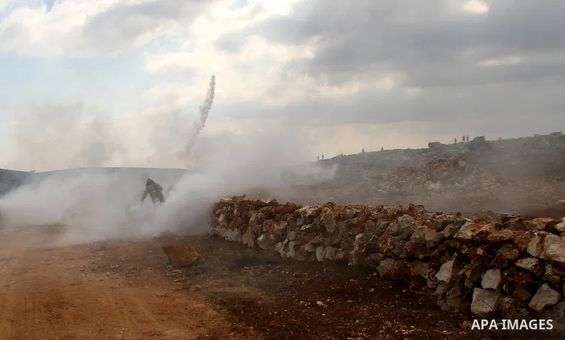A Palestinian youth throws back a tear gas canister fired by Israeli security forces during clashes following a confrontation between Palestinians and Jewish settlers, in the West Bank village of Qusra, near Nablus, Feb....