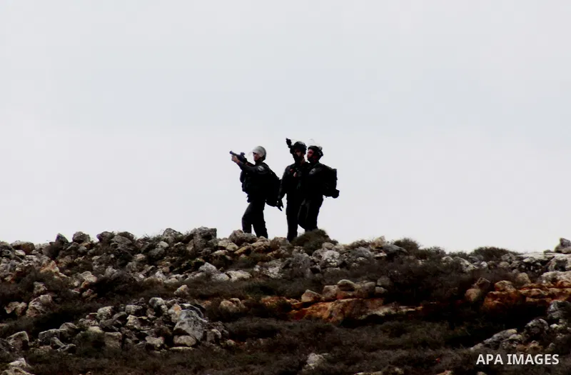 Israeli security forces fire tear gas at Palestinian youth during clashes following a confrontation between Palestinians and Jewish settlers, in the West Bank village of Qusra, near Nablus, Feb. 6, 2014. Clashes broke ou...