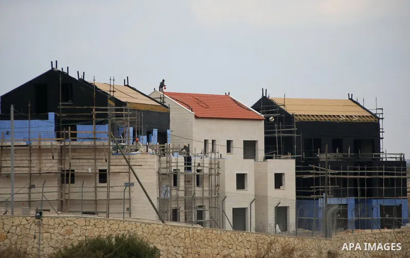 Construction laborers work at the site of a new housing unit in the Settlement of Vrata, southern the West Bank City of Bethlehem, Feb. 06, 2014. Israeli officials have given final approval for 558 new apartments in Jewi...