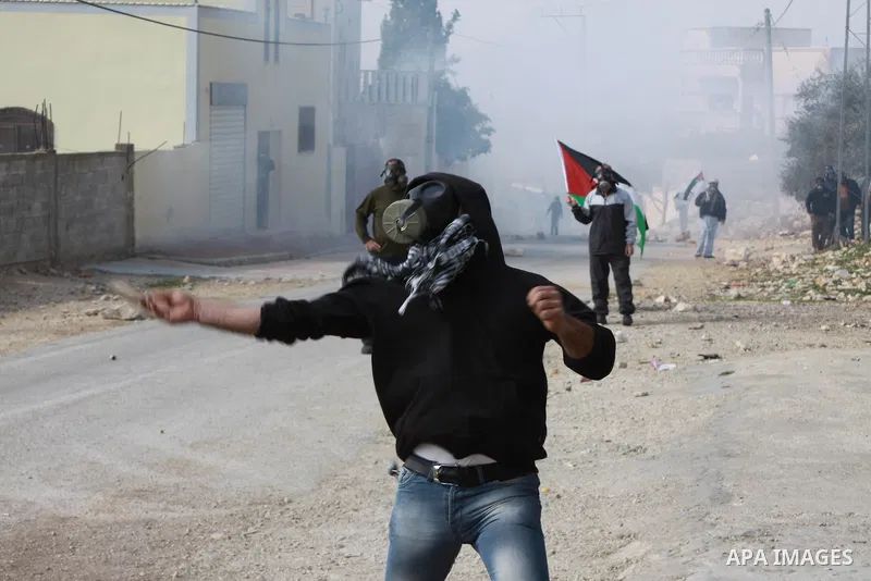 Palestinian protesters hurl stones during clashes over the Jewish settlement of Qadomem, near Nablus, West Bank,7 February 2014. Five Palestinians were reportedly wounded during the clashes accompanying the weekly Friday...