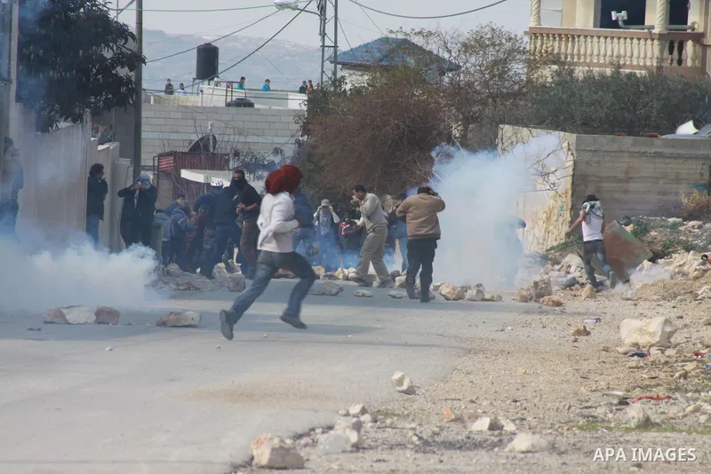 Palestinian protesters hurl stones during clashes over the Jewish settlement of Qadomem, near Nablus, West Bank,7 February 2014. Five Palestinians were reportedly wounded during the clashes accompanying the weekly Friday...