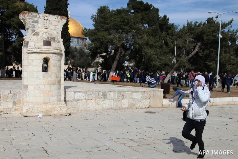 Palestinians throws a stone during clashes with Israeli police after Friday prayers on the compound known to Muslims as Noble Sanctuary and to Jews as Temple Mount in Jerusalem's Old City February 7, 2014. Israeli police...