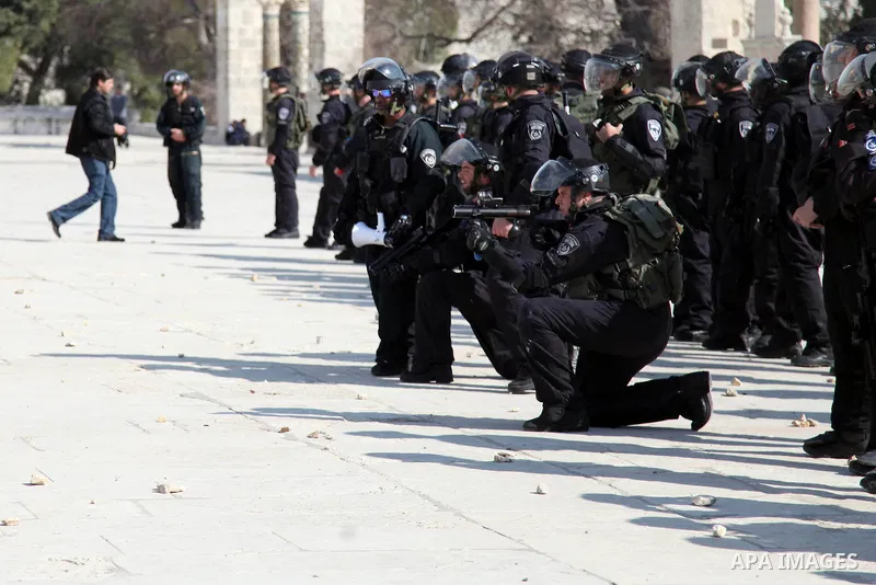 Israeli policeman aims his rubber bullet launcher during clashes with stone-throwing Palestinians after Friday prayers on the compound known to Muslims as Noble Sanctuary and to Jews as Temple Mount in Jerusalem's Old Ci...