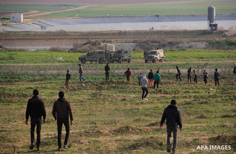 Palestinians throw stones during clashes with Israeli forces near the border with Israel, east of Jabalia refugee camp in northern Gaza Strip on February 7, 2014. The Israeli army fired live rounds and tear gas at protes...