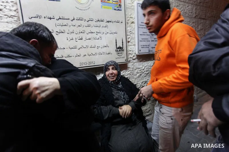 Palestinian relatives of Ibrahim al-Saidi, 25, at the morgue of Al-Aqsa hospital in Deir Al Balah, central Gaza Strip, Feb. 07, 2014. A Palestinian was killed and two others were injured on Friday evening in an explosion...