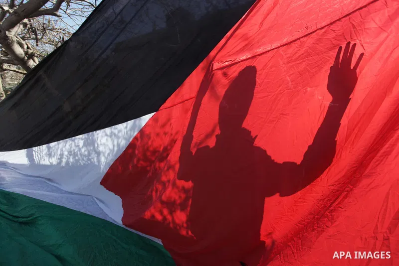 ِِِِِA Palestinian man waves his national flag during a moot court against of the war criminals Prime Minister of Israel Benjamin Netanyahu, and former Prime Minister Ehud Barak in front of the headquarters of the United...