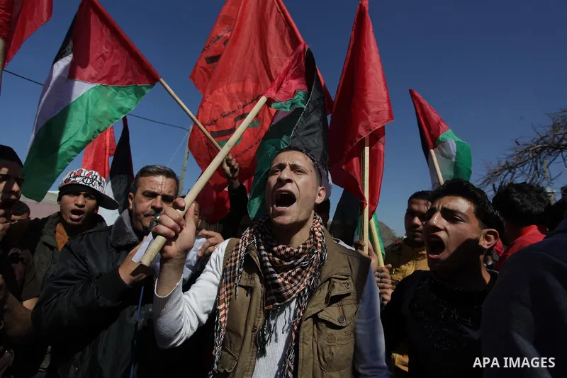 ِِِِِA Palestinian man waves his national flag during a moot court against of the war criminals Prime Minister of Israel Benjamin Netanyahu, and former Prime Minister Ehud Barak in front of the headquarters of the United...