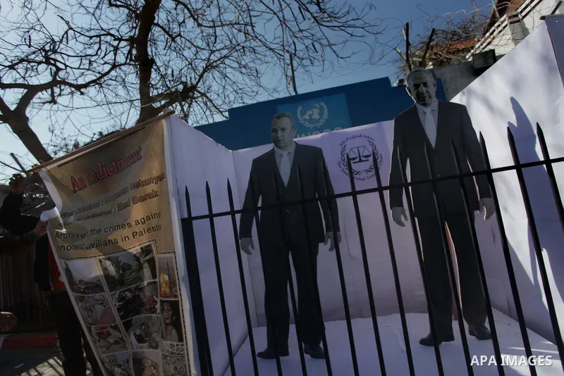 ِِِِِA Palestinian man waves his national flag during a moot court against of the war criminals Prime Minister of Israel Benjamin Netanyahu, and former Prime Minister Ehud Barak in front of the headquarters of the United...