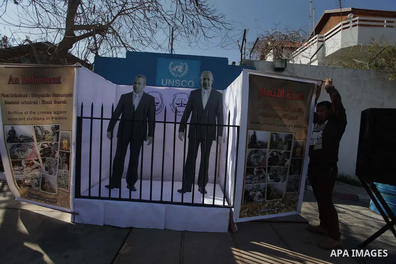 ِِِِِA Palestinian man waves his national flag during a moot court against of the war criminals Prime Minister of Israel Benjamin Netanyahu, and former Prime Minister Ehud Barak in front of the headquarters of the United...