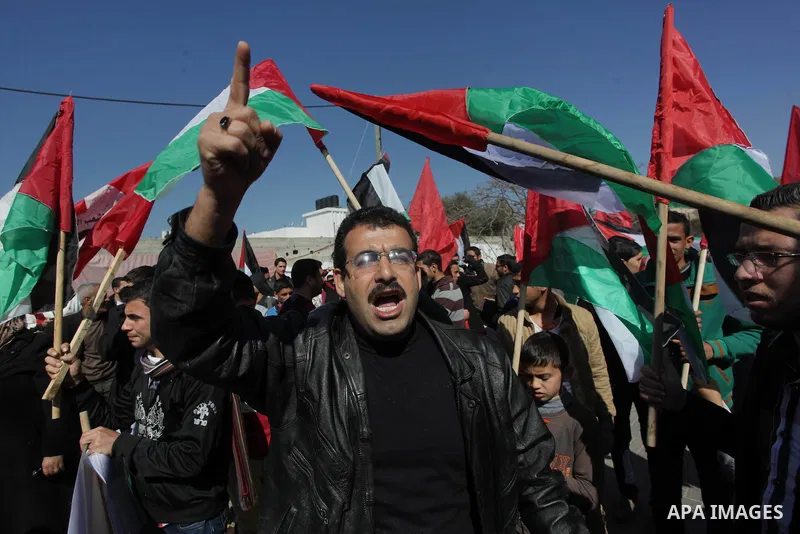 Supporters of Palestinian People's Party wave their national flag during a moot court against of the war criminals Prime Minister of Israel Benjamin Netanyahu, and former Prime Minister Ehud Barak in front of the headqua...
