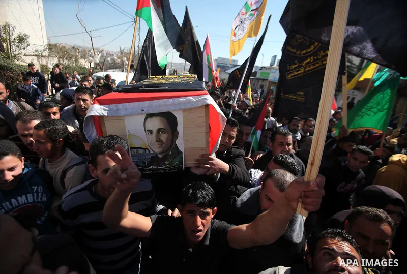 Palestinians carry a coffin containing the remains of Ahmed al-Faqih, during a funeral in the West Bank village of Dura, southeast of Hebron, Feb. 10, 2014. Israel on Sunday evening delivered the remains of Ahmad Ayid Fa...